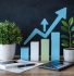 Business growth concept with ascending bar chart and upward trending arrow in blue and green, flanked by small potted plants. Financial documents, calculator, and pen in foreground on wooden desk, symbolizing accounting practices driving sustainable business growth.
