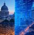 Split image showing a contrast between classical and modern cityscapes: the left side features traditional European architecture with a historic domed building at dusk, while the right side depicts a futuristic digital city with glowing blue skyscrapers and data-like grid overlays, symbolizing the transition from physical to digital infrastructure.