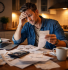 UK small business owner surrounded by tax documents and receipts struggling with accounting before hiring professional small business accounting services