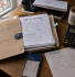 Wooden desk with HMRC envelopes, P60 form, calculator and tea showing tax return paperwork in the UK