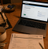 UK landlord completing SA105 form to report rental income to HMRC on laptop with paperwork and keys on table