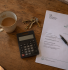 Tax on rental income UK paperwork on kitchen table with HMRC self assessment letter and house keys