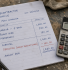 Construction subcontractor invoice on a workbench showing a 20% CIS tax deduction on labour