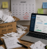 Box of paper receipts next to a laptop showing cloud accounting software, illustrating how long to keep accounting records