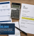 Flat-lay of UK payslip, calculator and HMRC letter illustrating unclaimed small business tax relief.
